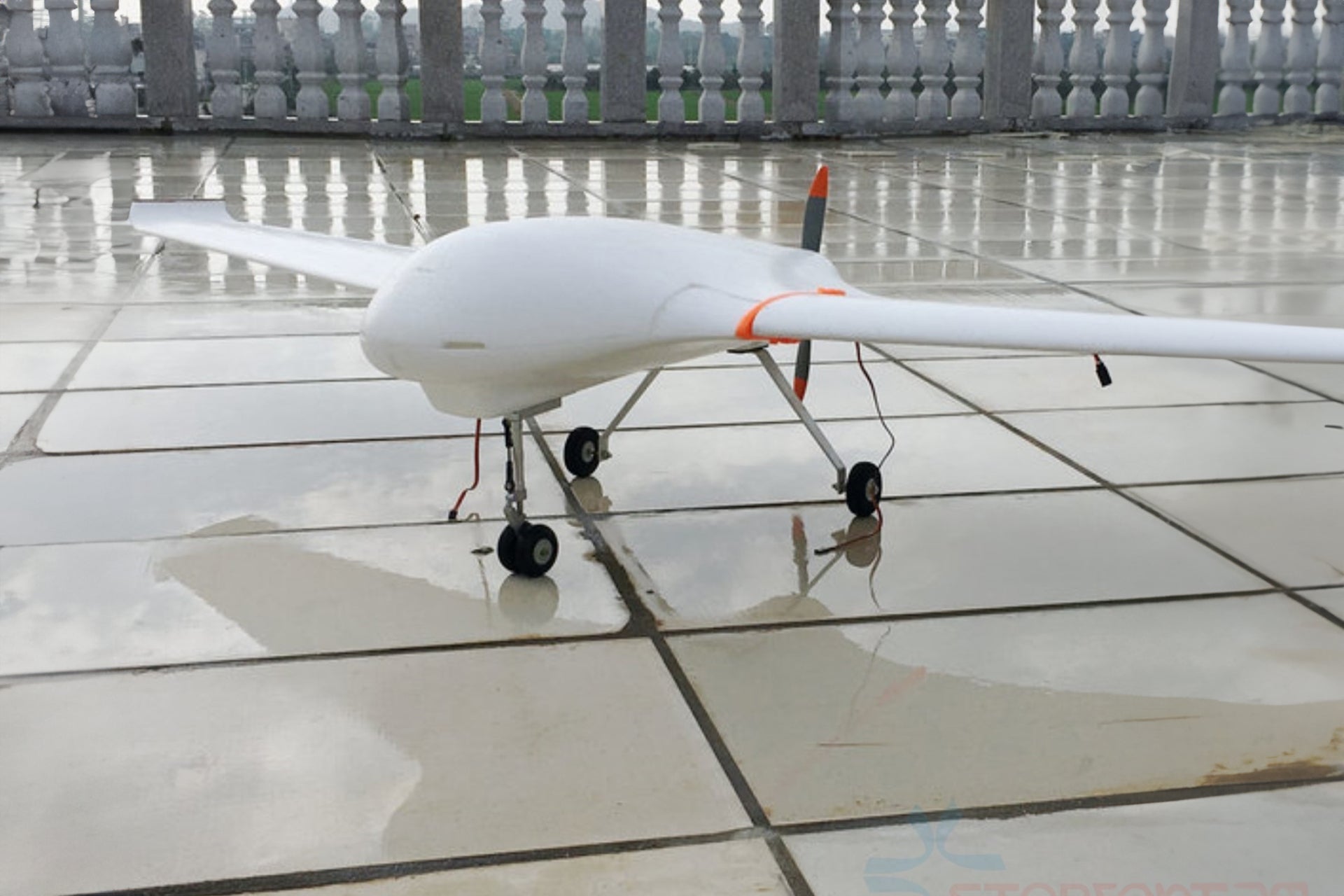 Aluminum alloy landing gear for Skywalker x8 EPO airplane on tiled surface.